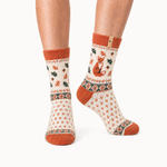Autumn Fox merino wool crew socks for women, a fox among fallen leaves in rust on cream