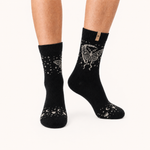 Luna Moth merino wool crew socks for women, a cream moth and scattered stars on black